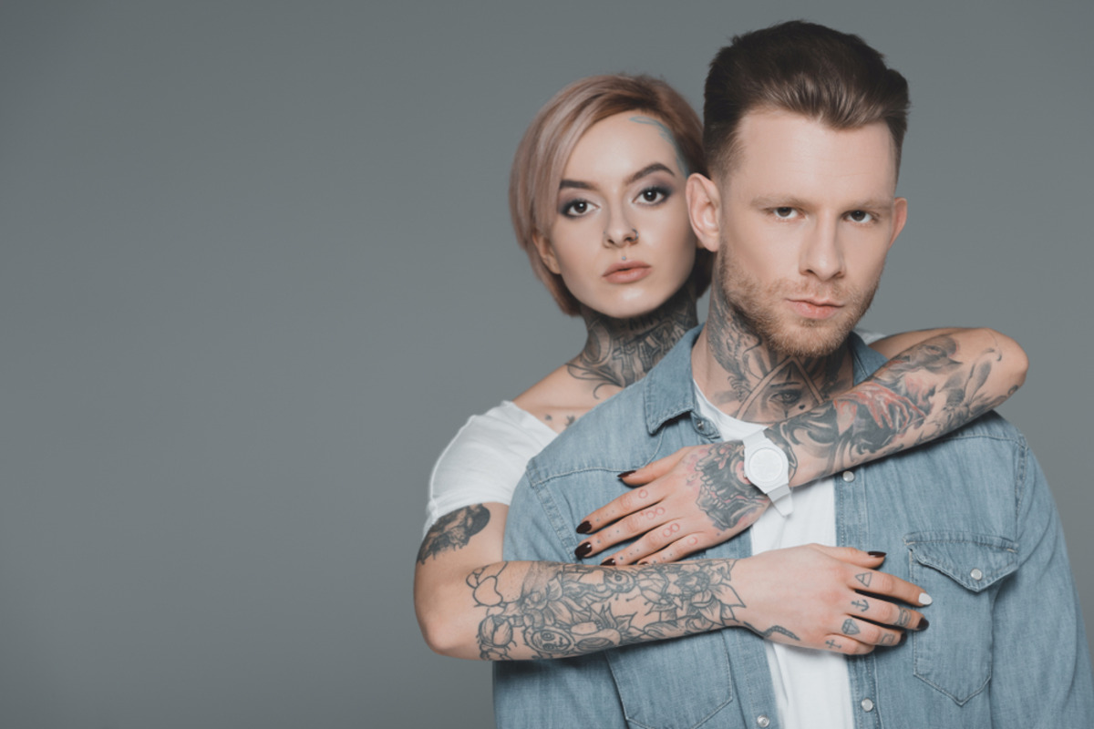 man and woman with visible tattoos